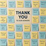 A thank-you wall covered in handwritten notes and donor names, centered around a bold 'THANK YOU' sign, symbolizing appreciation and community support.