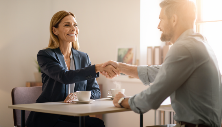 A nonprofit executive director shaking hands with a marketing consultant
